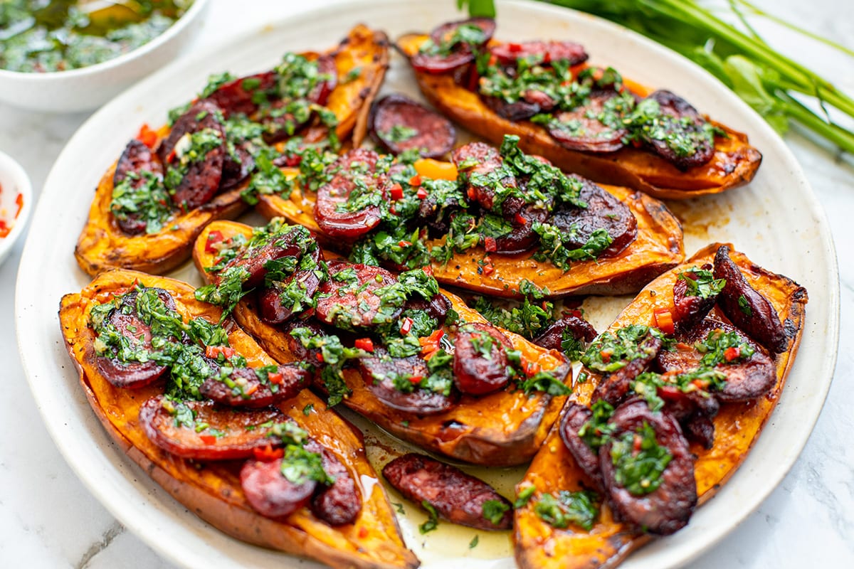 Grilled chorizo with chimichurri sauce over baked sweet potato halves, served with broccolini - paleo, whole30, gluten-free