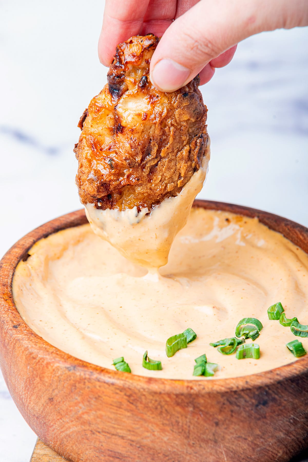 bang bang sauce recipe with chicken dipped into it