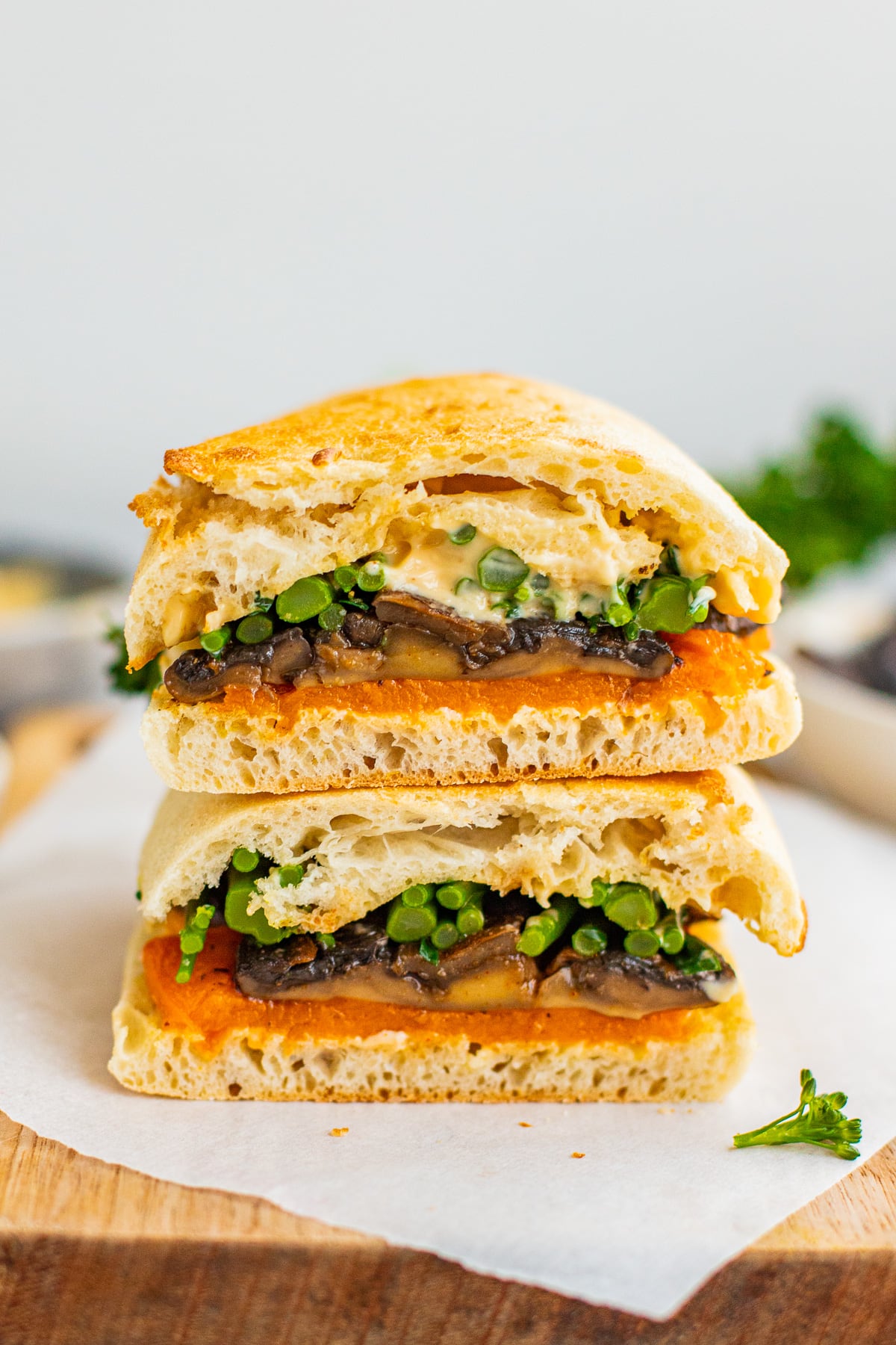 mushroom sandwich with broccolini and butternut squash halved